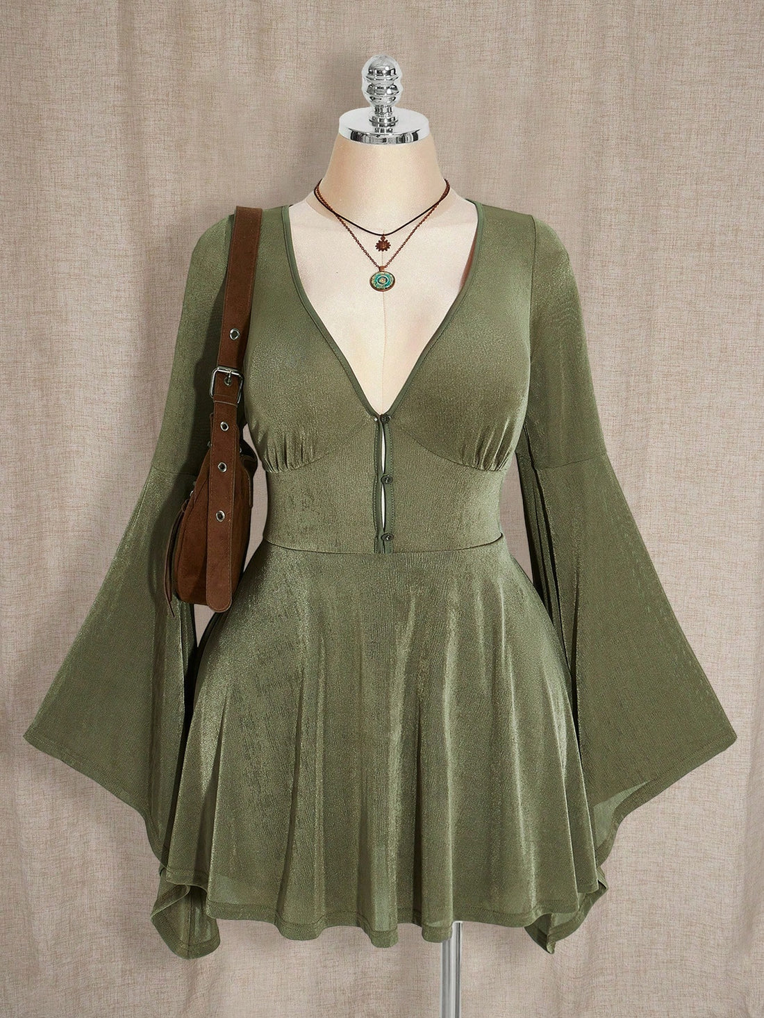 Embrace your inner forest fairy with this enchanting boho Y2K dress that celebrates curves and vintage vibes. The rich military green hue evokes earthy, mystical energy, while the flattering A-line silhouette skims beautifully over the body. Fluttery flare sleeves add a whimsical touch, and the V-neckline creates an elegant focal point. Perfectly sized for plus figures, this dress transitions seamlessly from cozy autumn gatherings to magical evening adventures. Mix it with your favorite vintage accessories 