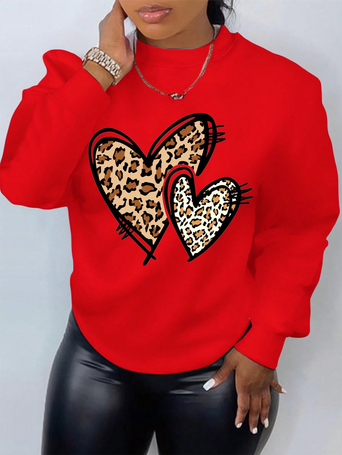 Add a touch of pizzazz to your wardrobe with this Bold & Stylish sweatshirt. The plus-size design features a heart and leopard print, perfect for making a statement. Stay trendy and cozy in the new year with this playful and eye-catching piece.
