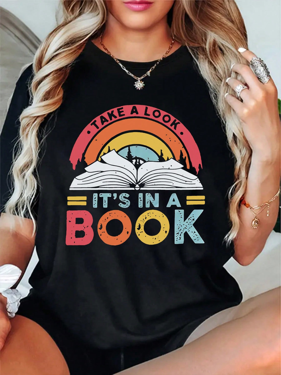 Celebrate your love for reading with this playful "Take A Look It's In A Book" T-shirt. Perfect for literature enthusiasts, it combines comfort and style, making it an ideal choice for cozy reading sessions or casual outings. Show off your bookish charm and spark conversations wherever you go!