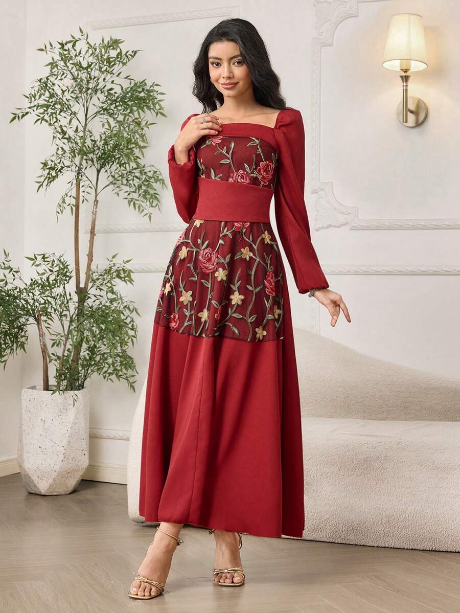 Front view of burgundy A-line maxi dress with floral embroidered mesh bodice and long puff sleeves