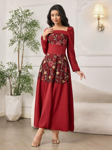 Front view of burgundy A-line maxi dress with floral embroidered mesh bodice and long puff sleeves