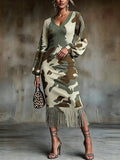 Front view of camouflage ribbed knit bodycon midi dress with V-neck, bishop sleeves and fringe hem