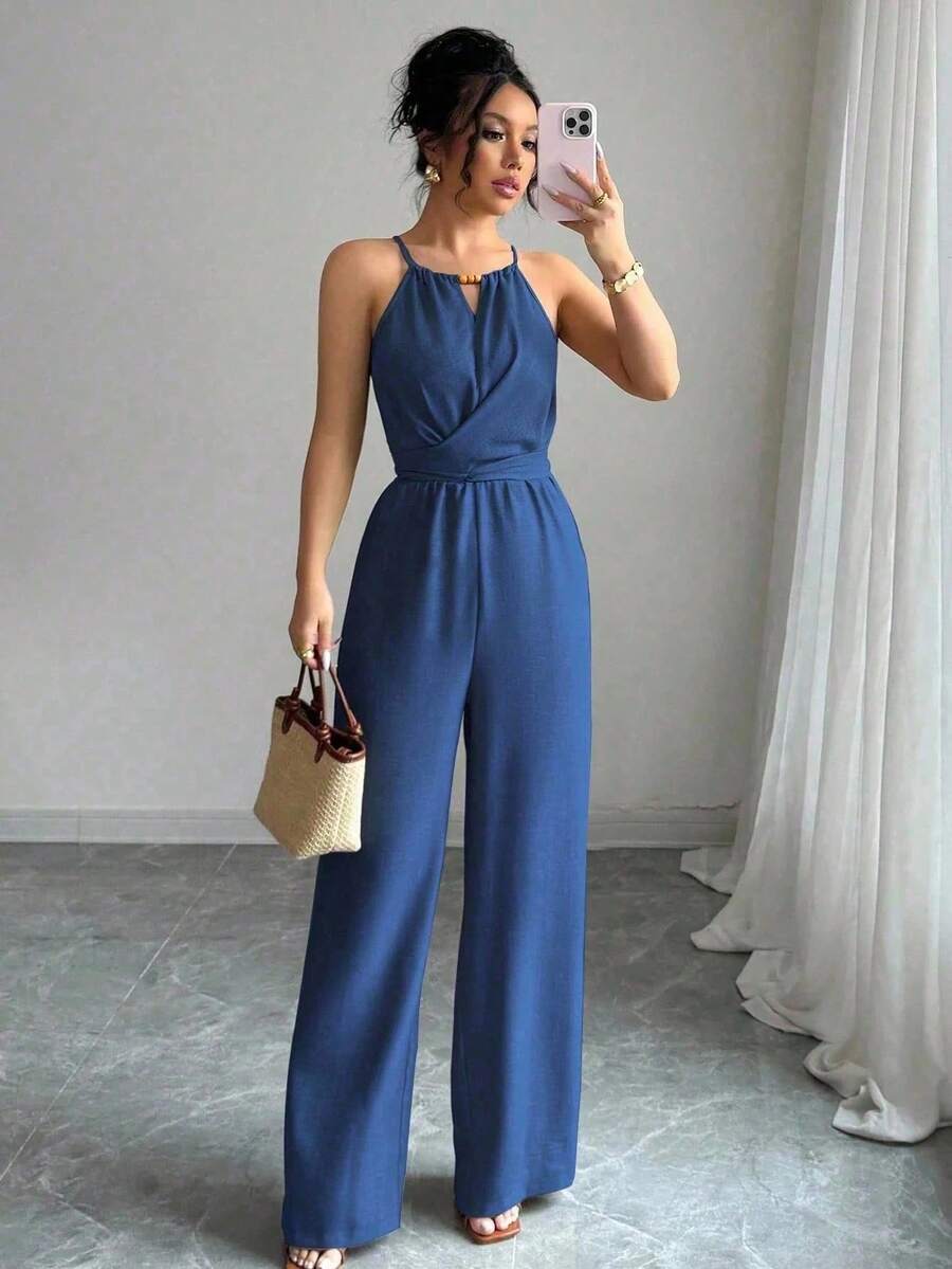 Effortless elegance meets spring style with this khaki crinkle fabric halter neck jumpsuit. The backless wrap design and criss-cross detailing create a flattering silhouette, while beaded accents add a touch of sophistication. High-waisted and unlined for a breathable fit, this casual piece transitions seamlessly from day to evening. Perfect for warm-weather occasions and festival celebrations. Crafted from 100% polyester woven fabric for a textured, dimensional look.
