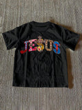 Front view of black women’s Jesus graphic T-shirt with multicolor faith artwork