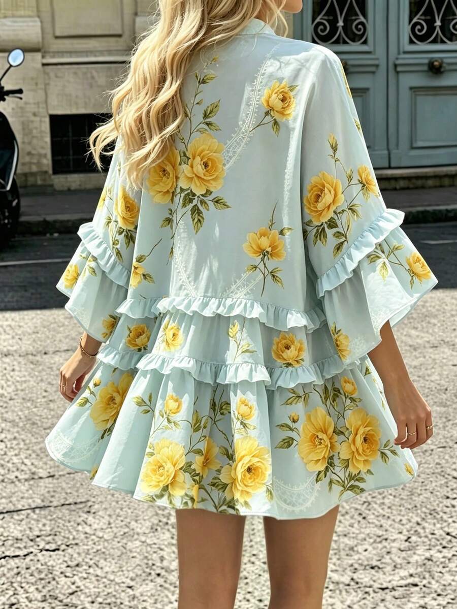 Front street view of mint floral bell-sleeve mini dress with tiered high-low ruffle hem
