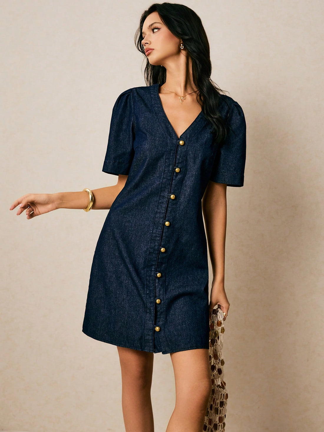 Step into summer with this playful V-neck denim midi dress, featuring charming puff sleeves that add a flirty touch. Its relaxed shift silhouette keeps you cool and comfortable all day long, while the classic blue denim brings effortless style to any casual outing. Perfect for sunny days and spontaneous adventures!