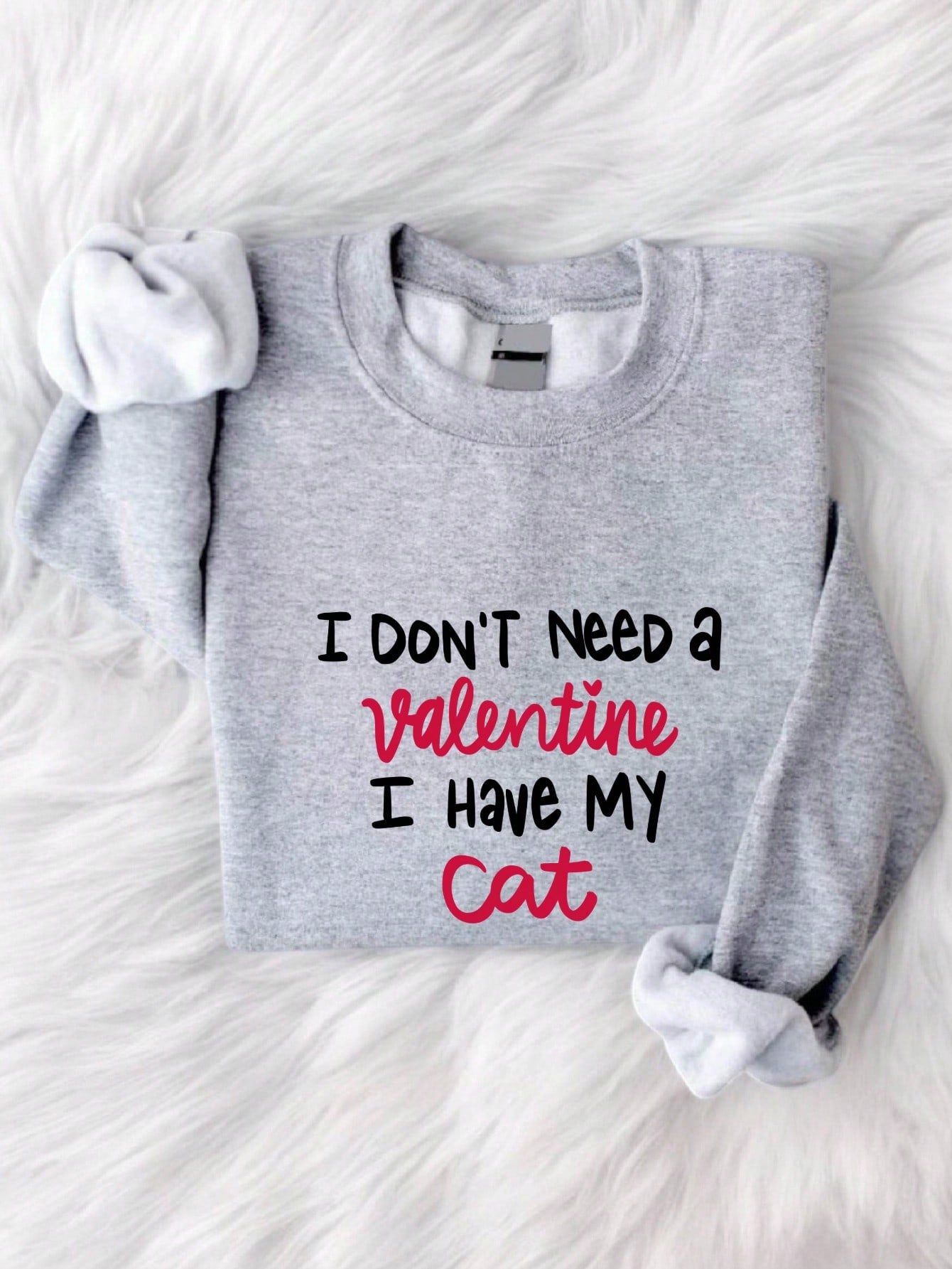 Show off your love for your feline friend this Valentine's Day with our Cat Lover Sweatshirt! Featuring the slogan "I Don't Need A Valentine I Have My Cat", this sweatshirt is perfect for those who don't take themselves too seriously. Stay cozy and stylish while expressing your quirky personality.