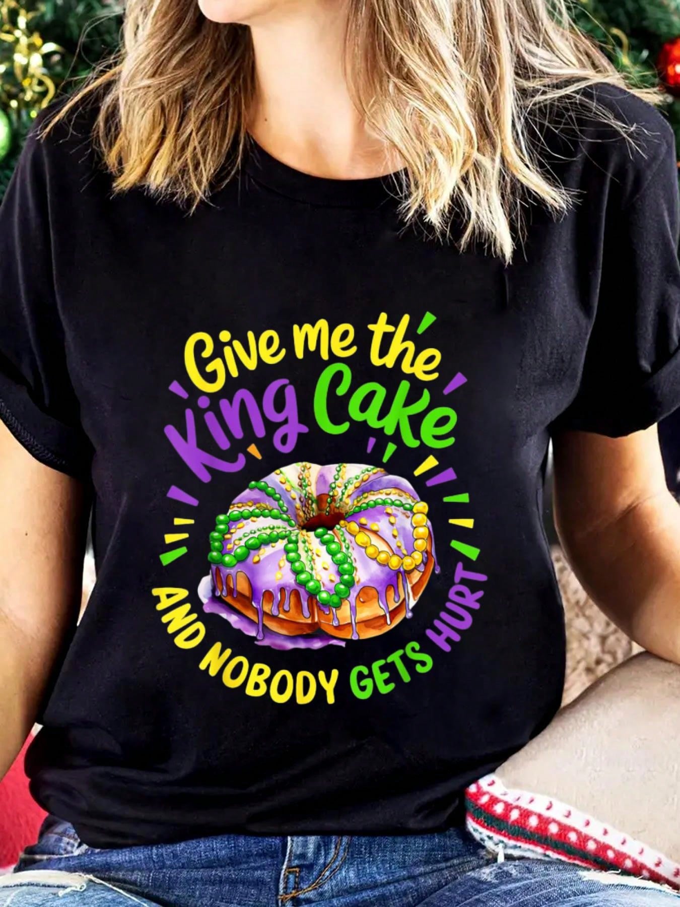 Celebrate Mardi Gras in style with this funny graphic t-shirt for women. Featuring the phrase "Give Me The King Cake" in bold and playful lettering, this shirt is perfect for adding some fun and humor to your Mardi Gras celebrations. Get ready to party in style with this quirky t-shirt!