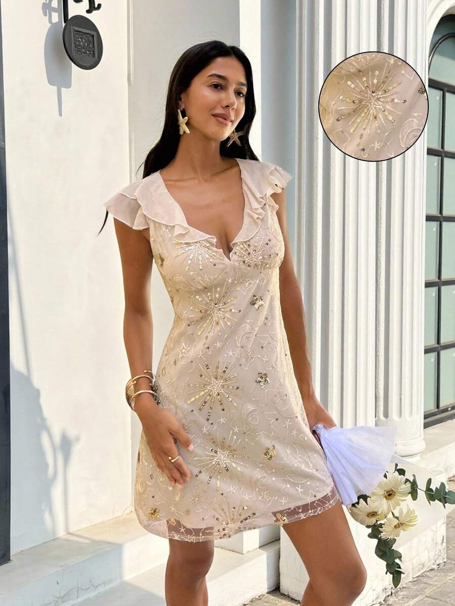 Front three-quarter view of champagne celestial sequin mini dress with deep V ruffle neckline