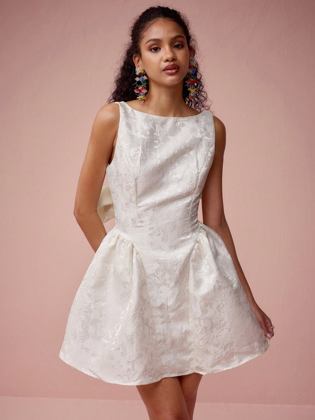 Unleash your charm and make a statement in this Charming Apricot Satin Jacquard Mini Dress. The perfect choice for romantic dates and special occasions, this dress features a big bowknot that adds a playful touch. Feel confident and fabulous in this stylish and unique dress.