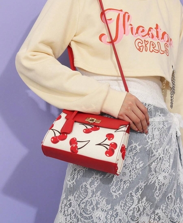 Add a pop of fun to your outfit with this Charming Cherry Print Handbag. Designed with a custom lock and a comfortable one-shoulder strap, this tote keeps your essentials secure and stylish. Perfect for running errands, brunch dates, or a day out, its vibrant cherry pattern brings a playful touch to any look. Light and roomy, it’s your go-to bag for every occasion that needs a little sweetness!