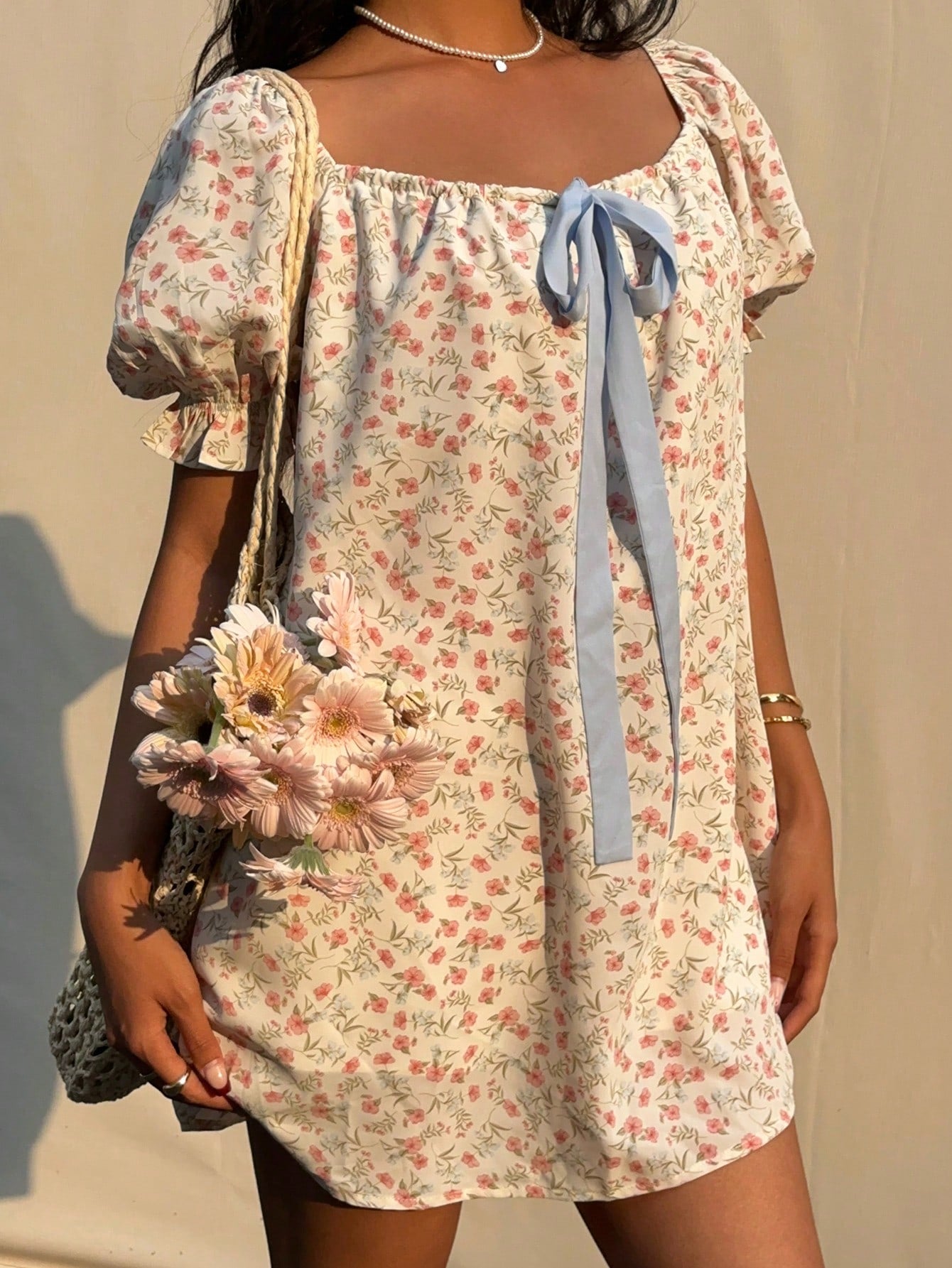 Step into sunshine with this Charming Ditsy Floral Mini Dress! Featuring a flirty square neckline and playful puff sleeves, it’s the perfect pick for breezy summer days. The delicate floral print adds a touch of whimsy, while the mini length keeps your look fresh and fun. Effortless style has never been so charming!