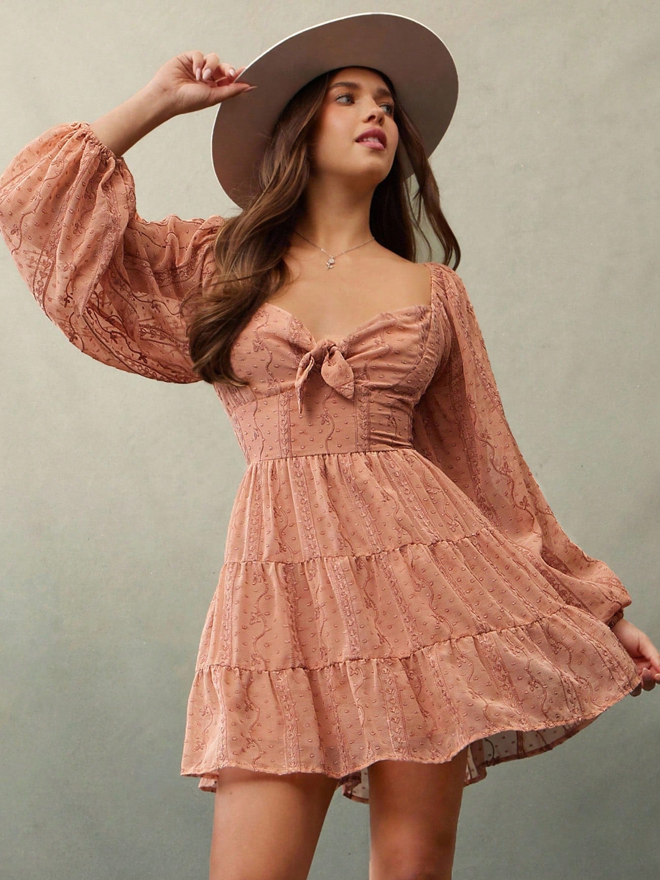 Twirl into autumn with this enchanting mini dress that's equal parts romantic and effortlessly cool. The delicate embroidered chiffon catches light beautifully, while the sweetheart neckline and playful puff sleeves add instant charm. Ruffled details dance along the hem, creating movement with every step. Perfect for layering over tees or pairing with boots, this boho beauty transitions seamlessly from festival vibes to cozy fall gatherings. Embrace your free-spirited style with a dress that feels as good a