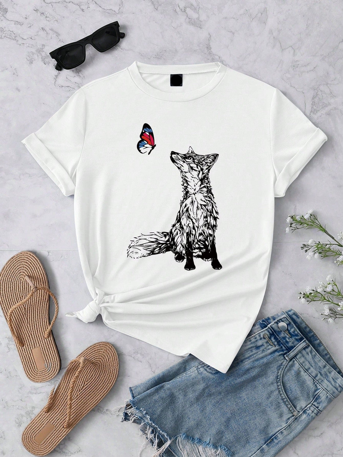 Add a touch of whimsy to your wardrobe with our Charming Fox and Butterfly Graphic Tee for Women. Made with a casual round neck and short sleeves, this tee features a playful design of a fox and butterfly. Perfect for any occasion, this tee is sure to charm with its comfortable fit and stylish print.