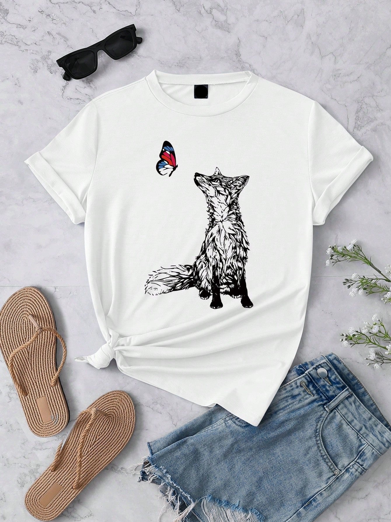 Add a touch of whimsy to your wardrobe with our Charming Fox and Butterfly Graphic Tee for Women. Made with a casual round neck and short sleeves, this tee features a playful design of a fox and butterfly. Perfect for any occasion, this tee is sure to charm with its comfortable fit and stylish print.