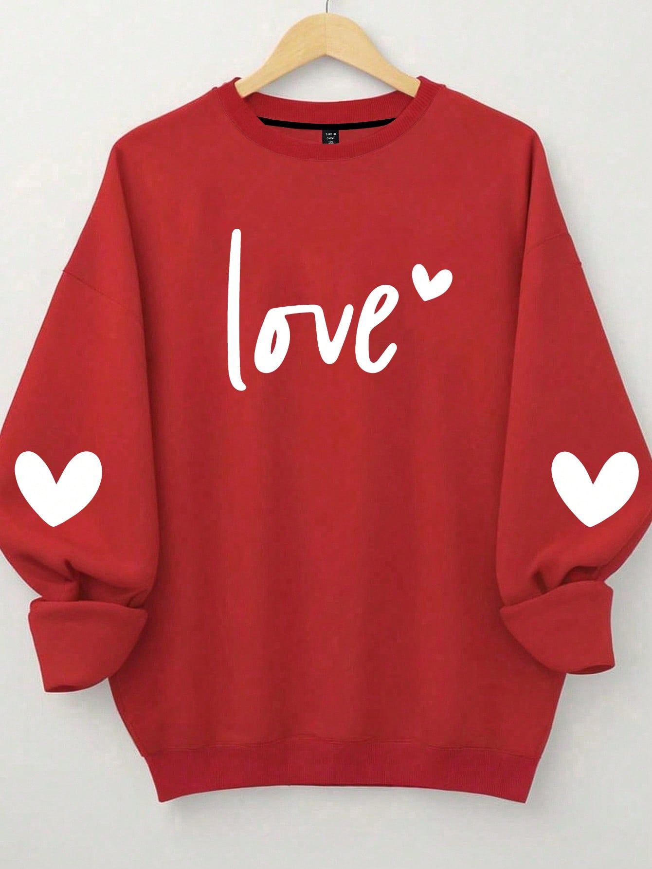 Ignite sparks of love with our Charming Love Letter Heart Print Plus Size Sweatshirt for Women. Cozy and stylish, this sweatshirt features a unique love letter heart print, perfect for showcasing your love for fashion. Feel confident and comfortable in this plus size sweatshirt.