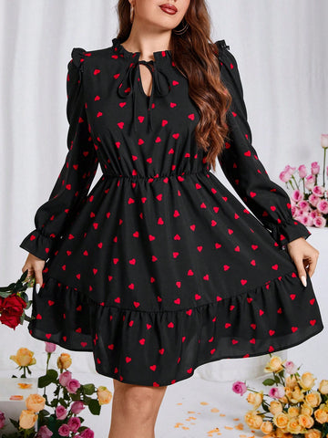 Get ready to charm your way through spring and Valentine's Day in this Charming Plus Size Heart Print Dress! With its playful heart print, tie-neck detail, and ruffled hem, this dress will give you a flirty and fun look. Perfect for any occasion, especially when you want to spread some love.