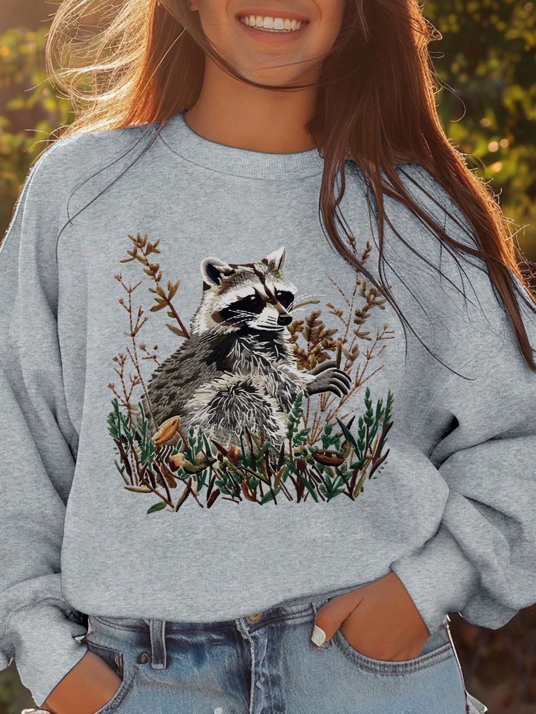 Introducing our Charming Raccoon Graphic Crew Neck Sweatshirt, perfect for relaxed days. Made with a cozy crew neck design and featuring a charming raccoon graphic, this sweatshirt is both comfortable and stylish. Ideal for any casual occasion, it's a must-have addition to your wardrobe.