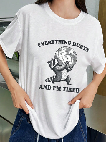 This Charming Raccoon Graphic Tee is not your average t-shirt. Featuring a fun slogan and a cute raccoon graphic, this round neck tee is sure to turn heads. Made for women, it combines style and comfort in one charming package. Perfect for any casual occasion, this tee is a must-have for your wardrobe.