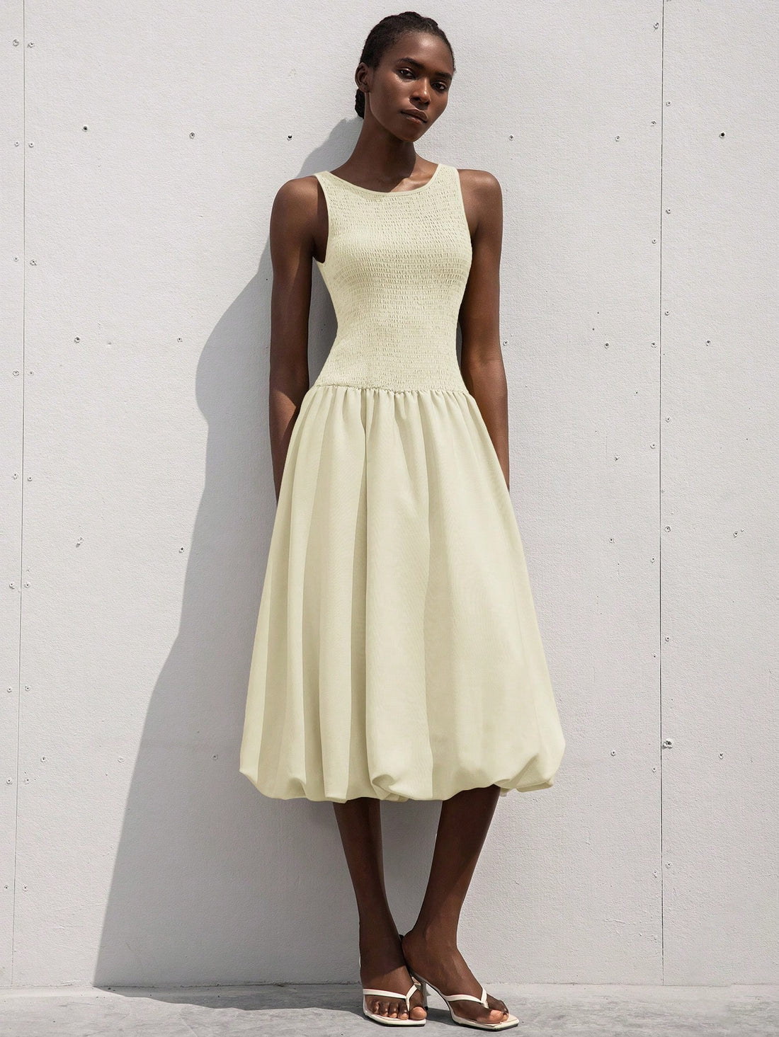 This playful sleeveless dress features a flirty ruffle hem and a drawstring waist that lets you customize your fit. Its light, breezy design makes it perfect for romantic outings or sunny days when you want to feel effortlessly charming. Add a touch of fun and femininity to your wardrobe with this delightful dress!