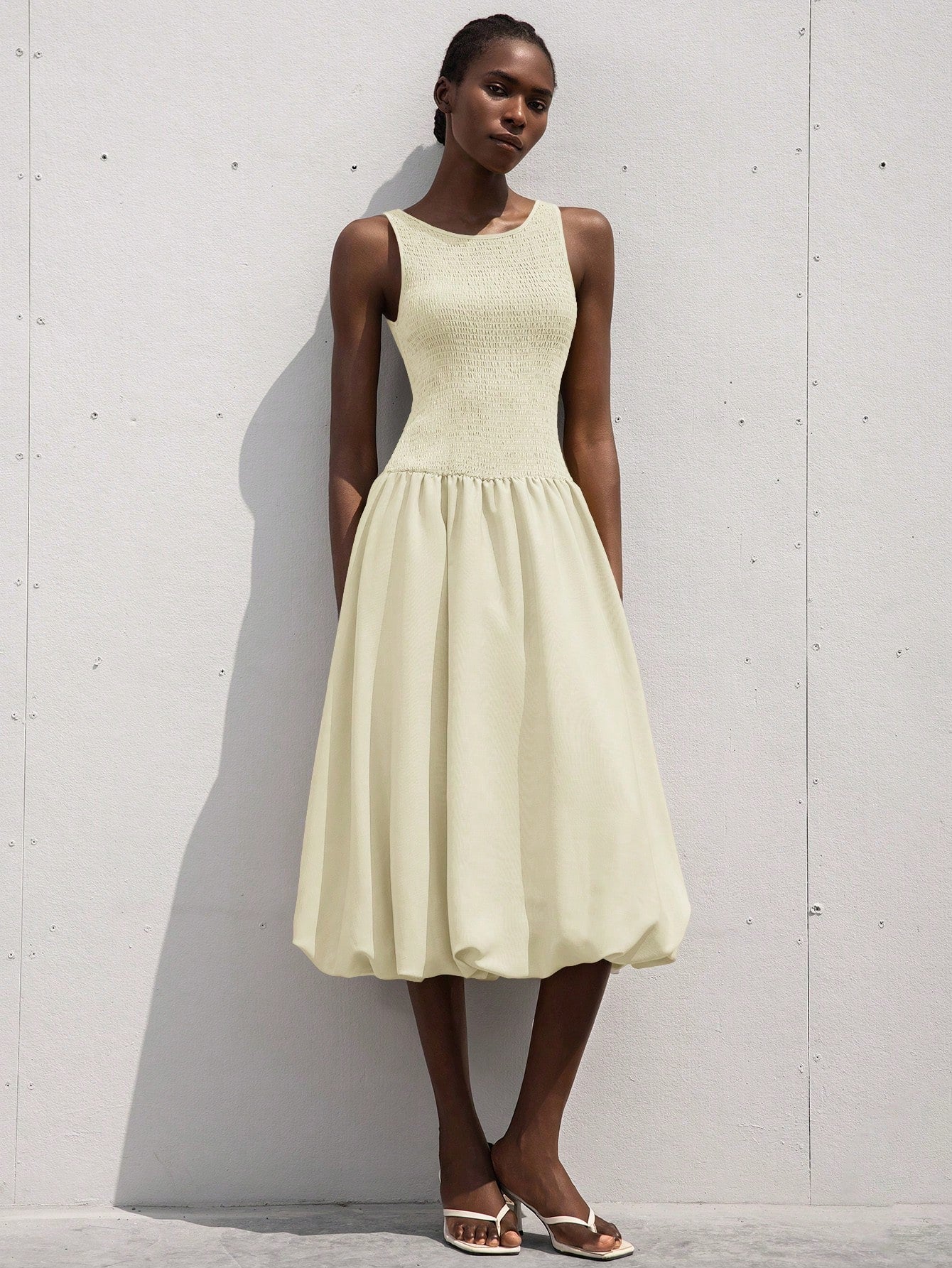 This playful sleeveless dress features a flirty ruffle hem and a drawstring waist that lets you customize your fit. Its light, breezy design makes it perfect for romantic outings or sunny days when you want to feel effortlessly charming. Add a touch of fun and femininity to your wardrobe with this delightful dress!