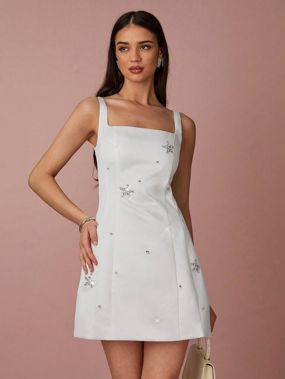 Say goodbye to boring dresses and hello to this Charming White Rhinestone Mini Dress! Perfect for summer vacations and special events, this dress features stunning floral decor and will make you stand out in any crowd. So why blend in when you can be charmingly unique?