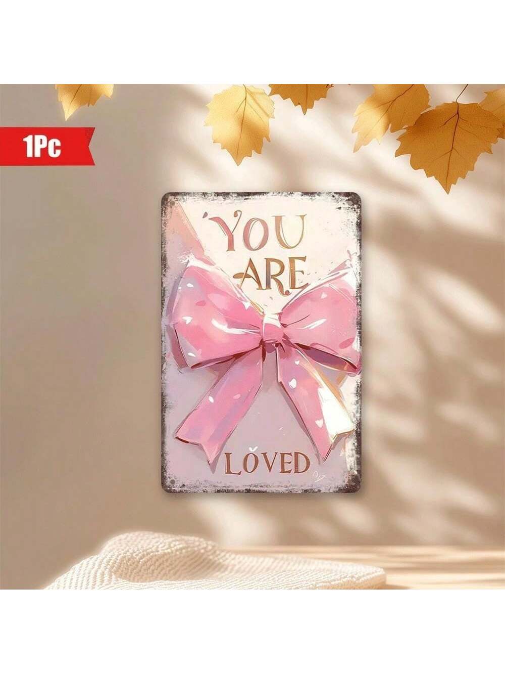 Add a charming touch to your home or café with this 'You Are Loved' Pink Bow Wall Art. The 8x12 inch decorative metal plaque features a sweet message to brighten any space. Show someone you care with this unique and playful piece of décor.