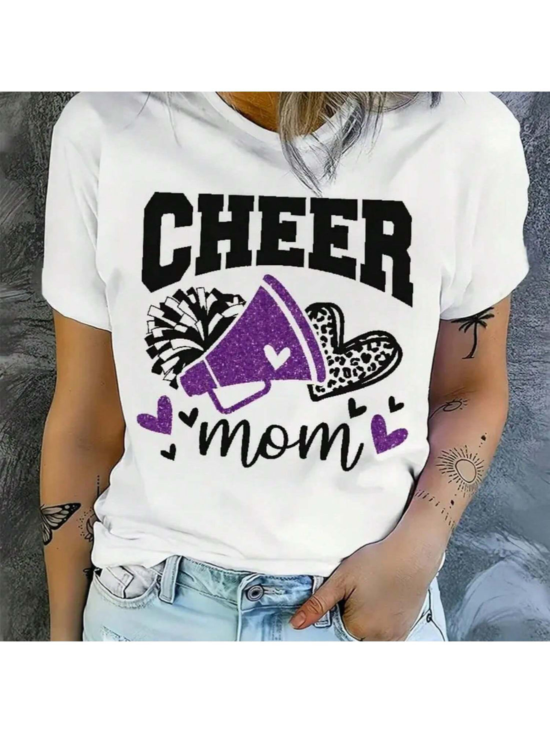 Get ready to cheer on your athlete in style with our Cheer Mom Graphic Tee! Made from a breathable polyester blend, this casual t-shirt is perfect for all seasons. Show off your team spirit with the playful and quirky design. (Go team!)