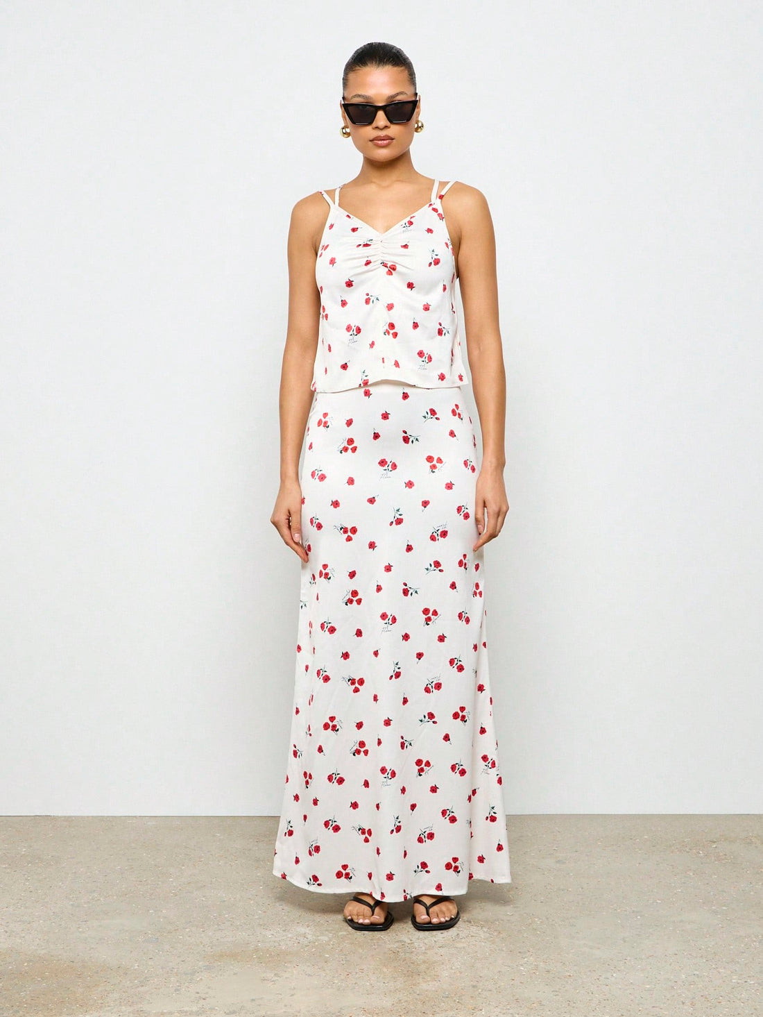 "Get ready to bloom this summer with our Cherry Blossom Floral Two-Piece Set! Featuring a perfect ruched cami top and maxi skirt, this set is perfect for your next resort getaway. Embrace the playful vibes with this unique and stylish ensemble. (P.S. It's also great for twirling under cherry blossom trees!)".