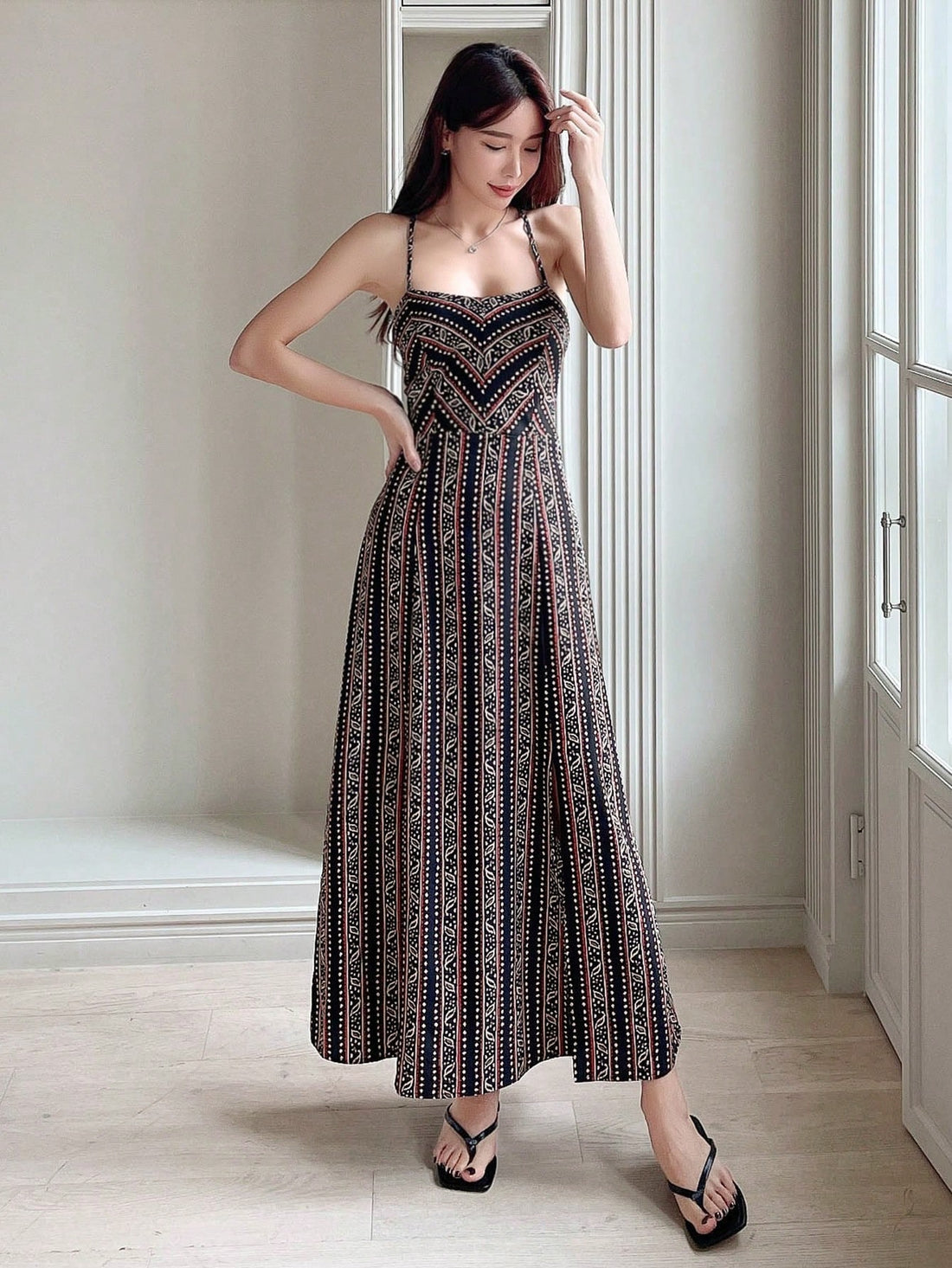 Effortlessly chic for any occasion! This all-over print cami dress features a fun and flirty lace-up backless design, perfect for showing off your playful and stylish side. Stay comfortable and stylish in this unique and versatile dress.