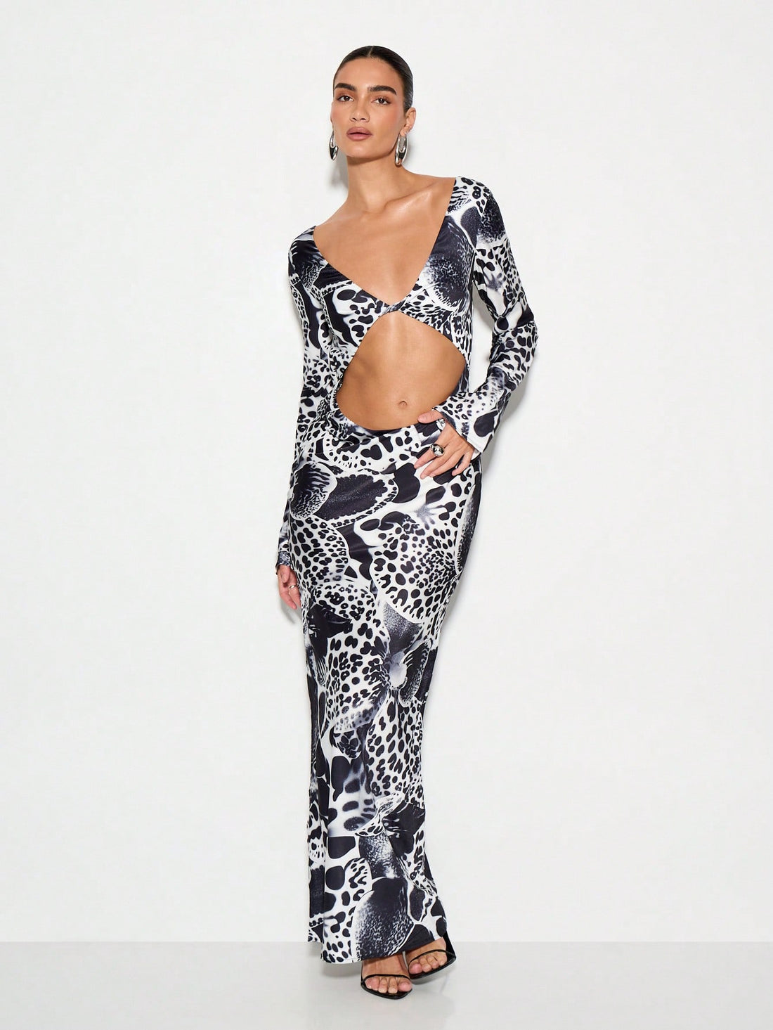 Make a statement at your next winter soirée in this stunning animal print maxi dress. The daring cut-out waist adds modern edge while the flowing silhouette flatters every figure. Crafted for those who love bold patterns and aren't afraid to turn heads, this dress transitions effortlessly from holiday parties to formal galas. The maxi length keeps things sophisticated, while the playful print brings personality to any occasion. Slip it on and let your confidence do the talking.