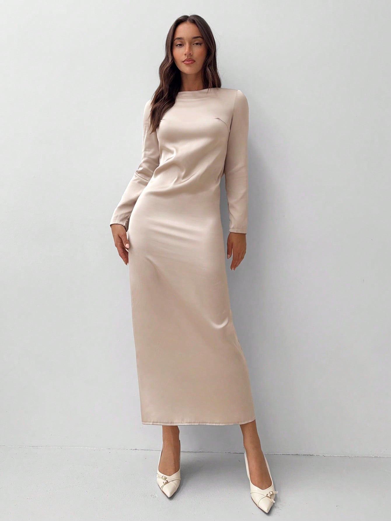 Turn heads in this stunning apricot bodycon dress that's equal parts bold and beautiful. The daring backless design and plunging neckline create serious statement-making appeal, while long sleeves add an unexpected touch of sophistication. Perfectly fitted to celebrate your curves, this piece transitions seamlessly from night out to special occasion. Slip it on and let your confidence do the talking—this dress demands attention and delivers pure glamour.