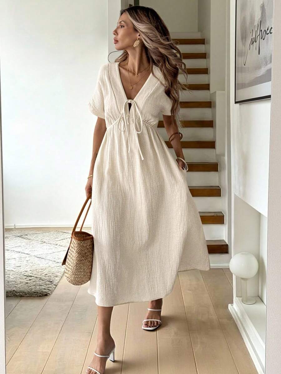 Elevate your everyday wardrobe with this charming apricot dress that strikes the perfect balance between effortless and elegant. The playful bow detail adds a touch of personality, while the relaxed short sleeves keep things breezy and comfortable. Cut to a flattering mid-length silhouette, it's your go-to piece for casual outings, weekend brunches, or laid-back dates. Pair it with sneakers for a fun vibe or dress it up with heels—this versatile number does it all with style and grace.