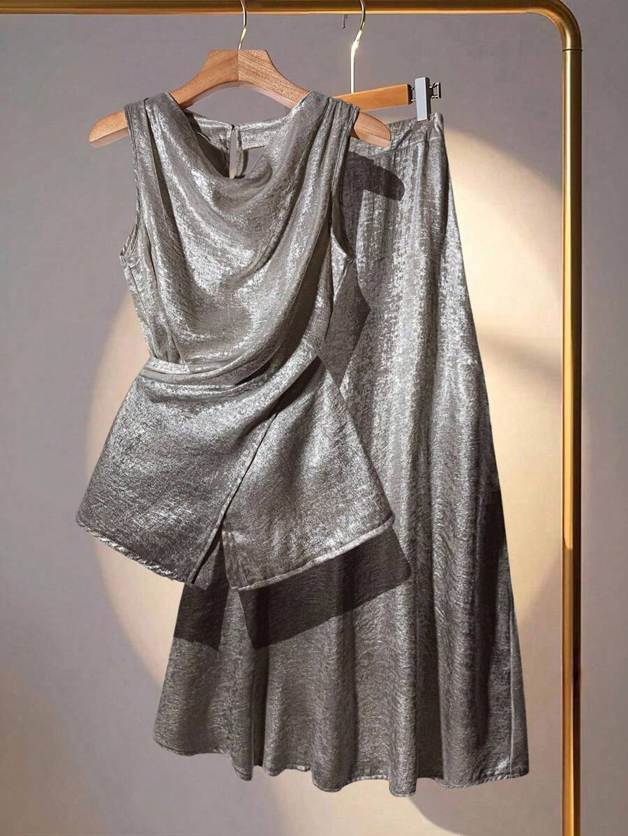 Elevate your wardrobe with this show-stopping two-piece set that effortlessly blends sophistication with fun! The asymmetrical draping blouse creates flattering, dynamic lines that move beautifully with you, while the metallic glitter midi skirt adds just the right amount of sparkle for those moments when you want to shine. Perfect for date nights, celebrations, or whenever you're ready to turn heads. Mix, match, or wear together—this versatile duo works hard so you don't have to think twice about looking f