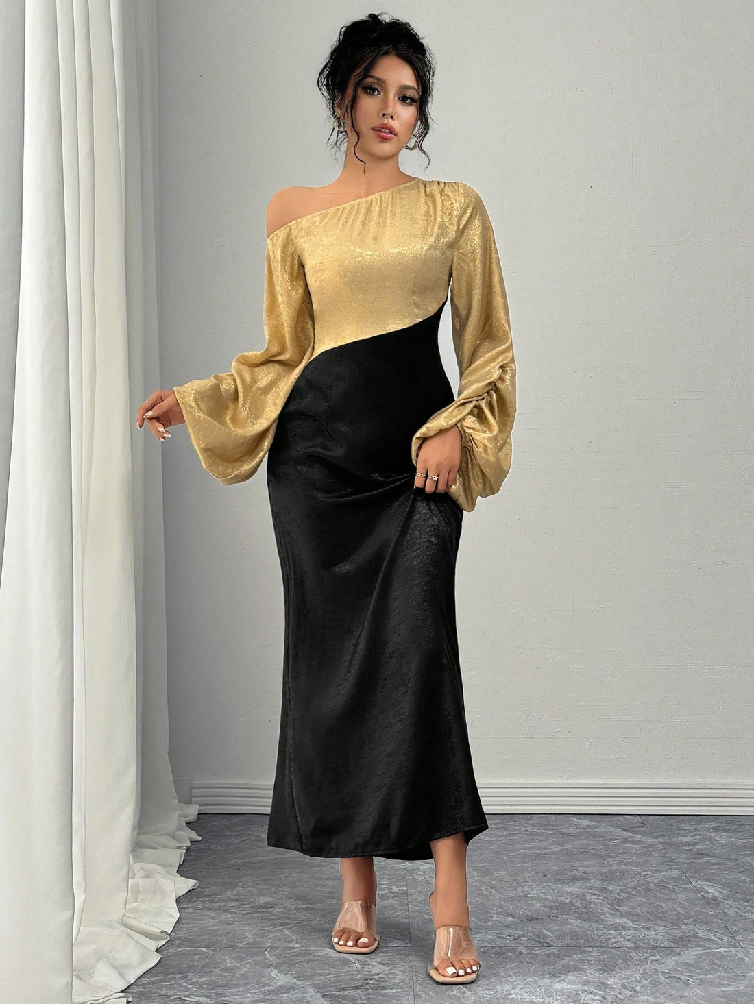 This elegant dress features chic asymmetrical lantern sleeves, creating an edgy yet sophisticated look. The midi length adds a touch of modernity, while the overall design exudes grace and charm. Perfect for any occasion, this dress is a must-have for those who want to make a statement.