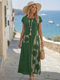 Green loose maxi dress front view with abstract side print panel and straw hat