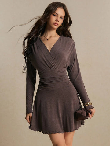 Front view of coffee-brown wrap mini dress with V-neck, gathered waist and lettuce-edge hem for fall outings