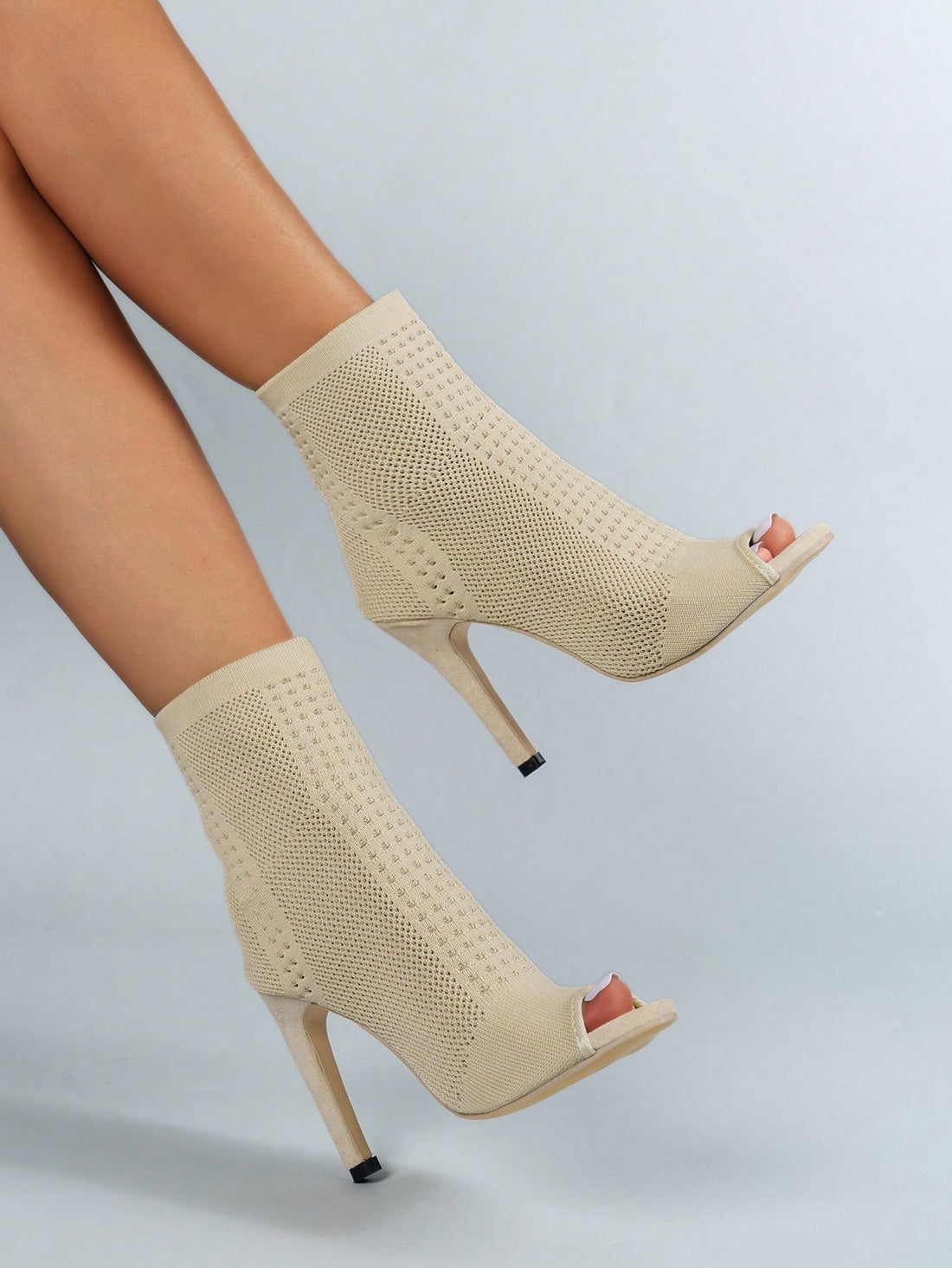 Kick up your style game with these chic beige pointed toe ankle boots. The high heel adds effortless height while the elastic knit provides a comfortable fit. Perfect for a fashion statement that's both stylish and easy. Step into style today!