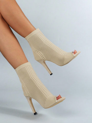 Kick up your style game with these chic beige pointed toe ankle boots. The high heel adds effortless height while the elastic knit provides a comfortable fit. Perfect for a fashion statement that's both stylish and easy. Step into style today!