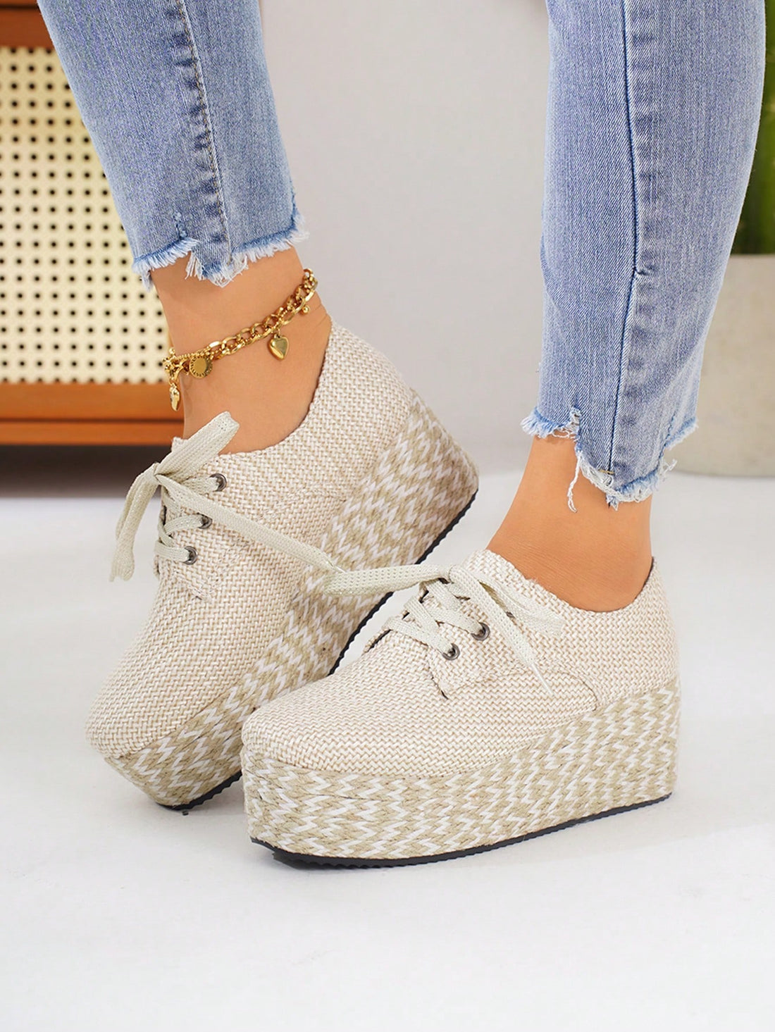 Step up your style game with these chic beige wedge platform shoes! Made from suede material and featuring a lace-up design, these shoes provide both comfort and fashion. With their dual-tone rope soles, they add a unique touch to any outfit. Elevate your look with these expertly-crafted shoes.