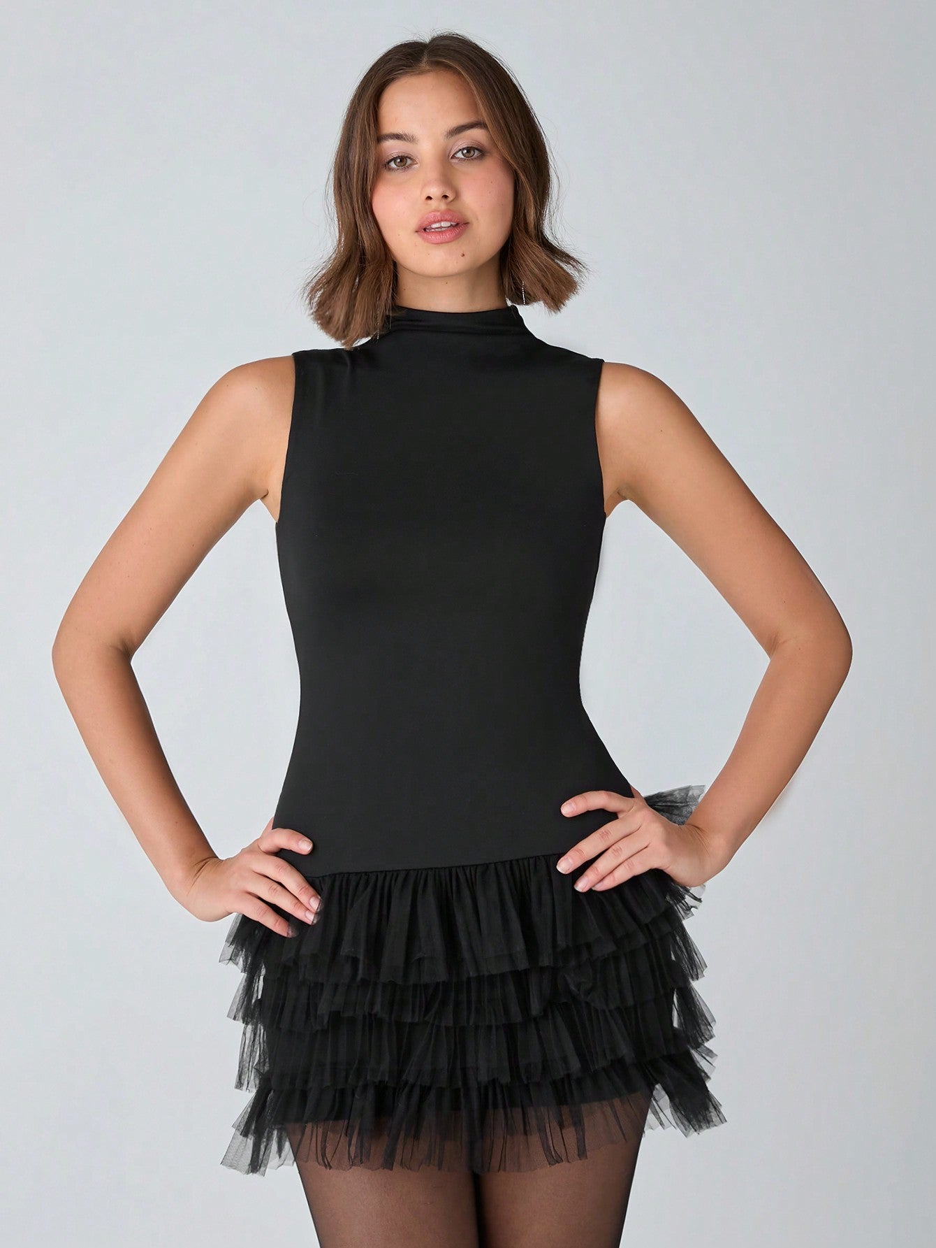 Be the life of the party in this Chic Black Bodycon Dress! With a romantic sleeveless design and mesh splicing, this dress is perfect for holiday parties and date nights. It's a must-have for any fashion-forward woman looking to make a statement.