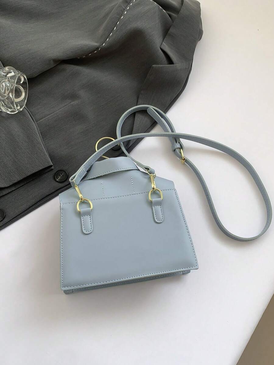 Elevate your style with this chic black collar-shaped crossbody bag, designed to turn heads and keep essentials close. Its playful flap design adds a unique twist, while the dedicated phone pouch ensures your device is always within reach. Perfect for hands-free adventures, this purse blends fashion and function effortlessly.