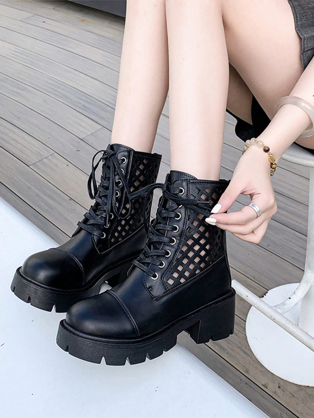 Step out in style with these chic black hollow lace-up boots, designed to add a playful edge to your daily commute. The chunky heel offers both comfort and confidence, while the hollow details keep your look fresh and breathable. Perfect for turning heads on the go without sacrificing practicality.