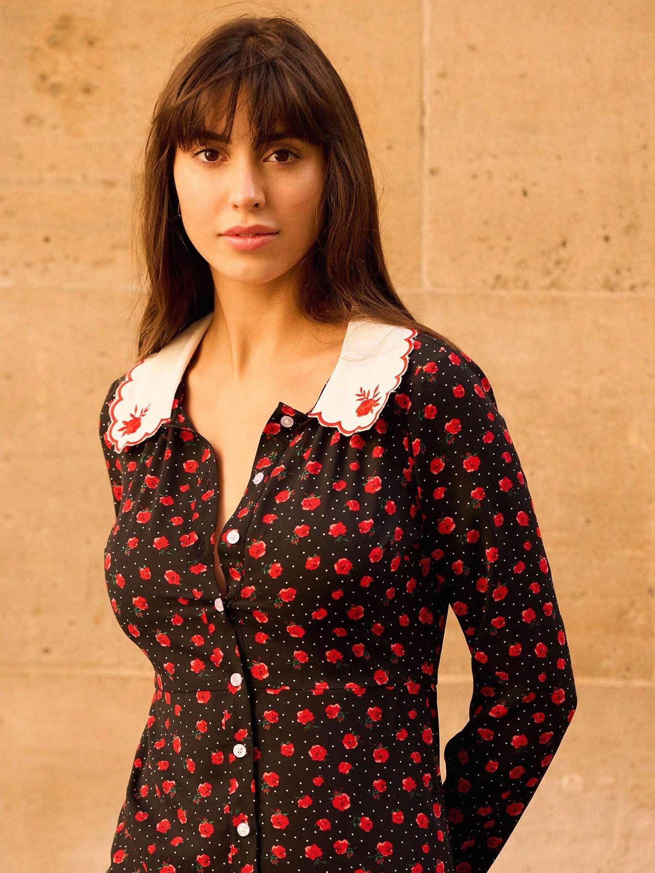 Elevate your autumn wardrobe with this stunning black mini dress that perfectly blends sophistication with seasonal charm. The vibrant red floral print adds a pop of color and personality, while the intricately embroidered collar brings an unexpected touch of elegance. Designed for effortless style, this dress transitions seamlessly from casual day outings to evening gatherings. The flattering mini silhouette pairs beautifully with boots, sneakers, or heels, making it a versatile staple for any fashion-forw