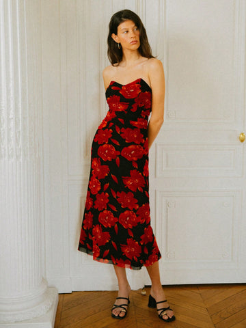 Turn heads in this stunning black midi dress featuring an elegant off-shoulder neckline and captivating red rose print. The flowing silhouette skims your curves beautifully, while the midi length offers sophisticated coverage that works for romantic date nights or wedding celebrations. Pair it with heels and statement jewelry for an unforgettable look that balances timeless elegance with modern flair. This versatile piece is your go-to for any occasion that calls for a touch of romance and style.