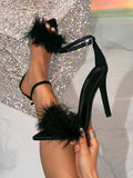 Front side close-up of black feather open-toe stiletto sandals with rhinestone ankle buckle