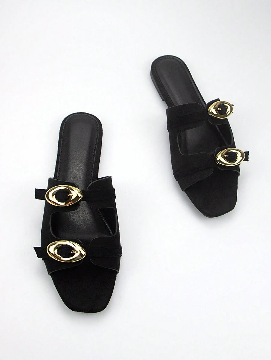 Elevate your everyday wardrobe with these sophisticated black suede mules, designed for effortless versatility. The adjustable strap with gleaming gold-tone buckle offers a customizable fit while adding a refined touch of elegance. Crafted from premium suede, these flat mules deliver comfort without compromising on style, making them an ideal choice for transitioning seamlessly from casual outings to more polished occasions. The minimalist silhouette pairs beautifully with dresses, jeans, or tailored trouse