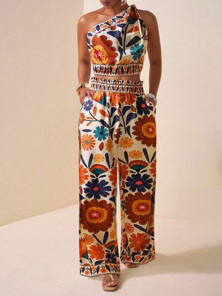 Effortlessly chic meets comfort in this stunning black two-piece set! The off-shoulder top brings a flirty, modern vibe perfect for showing off your style, while the loose-fitting trousers keep you cool and confident all day long. Whether you're heading to brunch with friends, a casual date night, or dressing up for something special, this versatile duo has you covered. The timeless black palette pairs with everything in your closet, making it the ultimate wardrobe MVP. Dress it down with sneakers or elevat