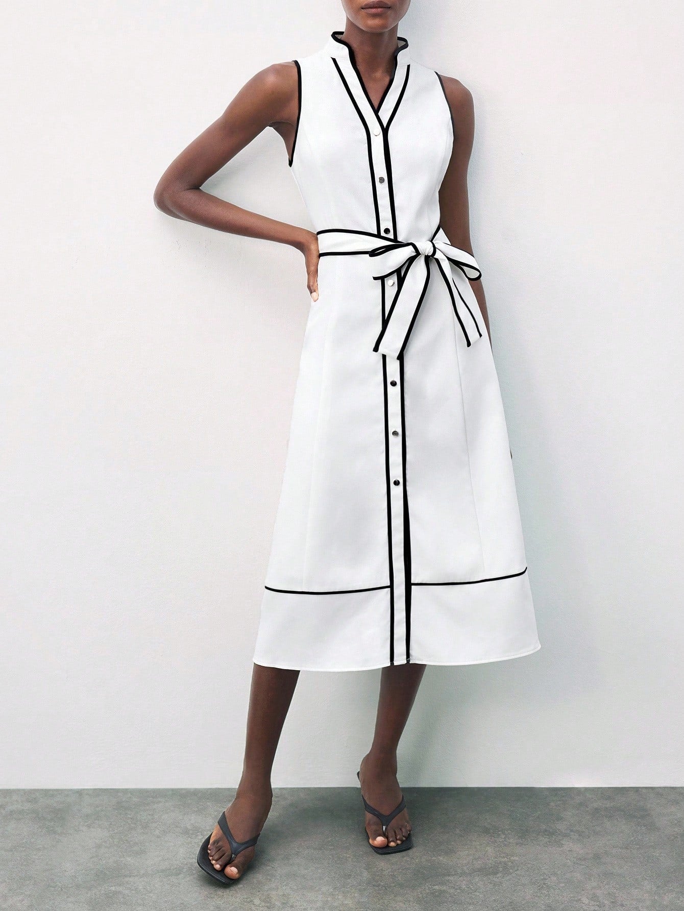Step into style with this chic black and white contrast shirt dress, perfectly blending elegant office sophistication with casual charm. The adjustable bow tie adds a fun, flirty touch while letting you customize your look for any occasion. Easy to wear and effortlessly stylish, this dress keeps you looking sharp and feeling comfortable from morning meetings to weekend brunches.