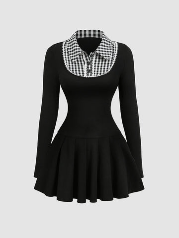 Full front view of black mini dress with checkered collar, button front, and pleated skirt